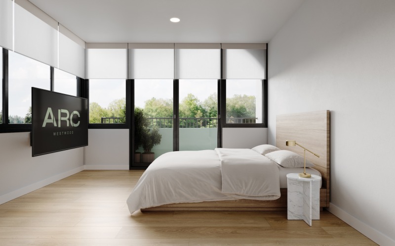 a bedroom with a large window and a tv