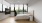 a bedroom with a bed, a tv and a large window