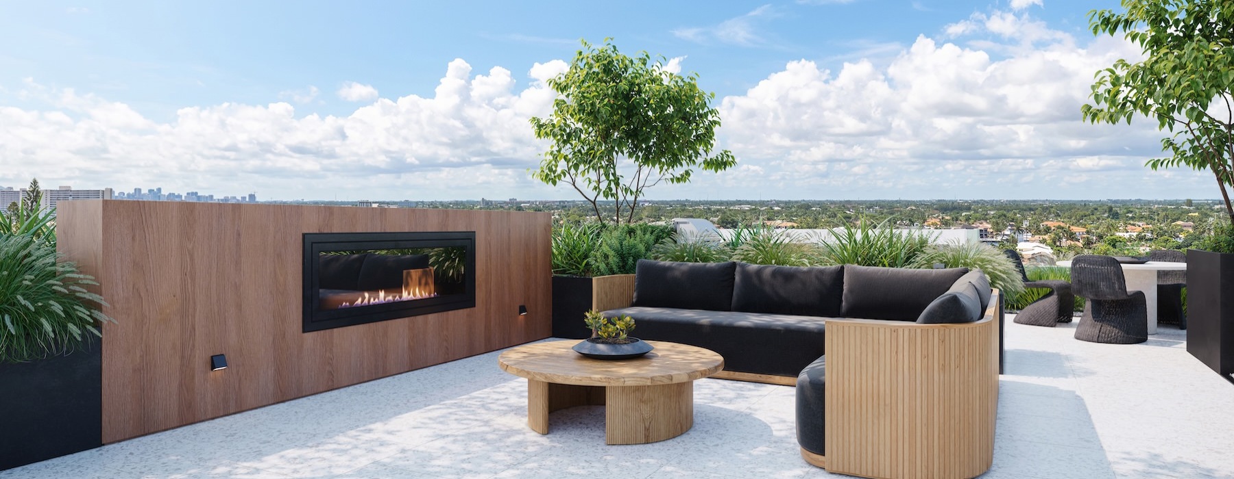 a rooftop lounge area with seating and a fire place